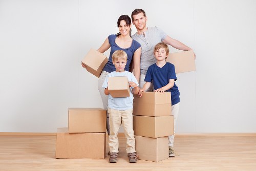 Packed business boxes and office equipment for relocation in Brompton