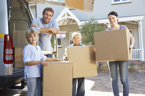 Local movers in Brompton unloading furniture and household items at a property