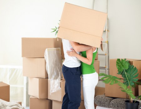 Packed moving boxes and furniture ready for local transport in Brompton