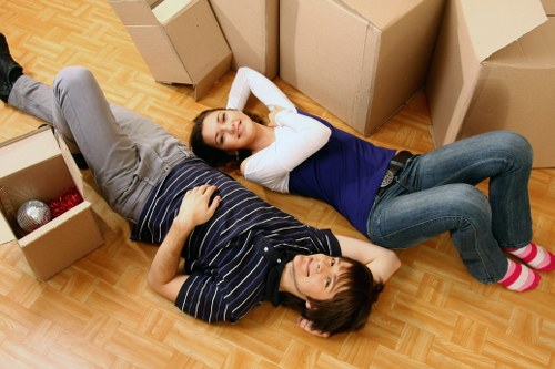 Careful loading of household items into a moving van in Brompton
