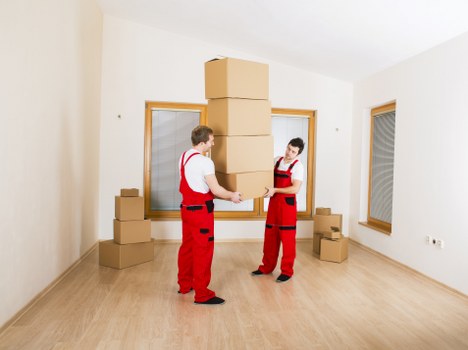 Professional movers handling office relocation items in Brompton